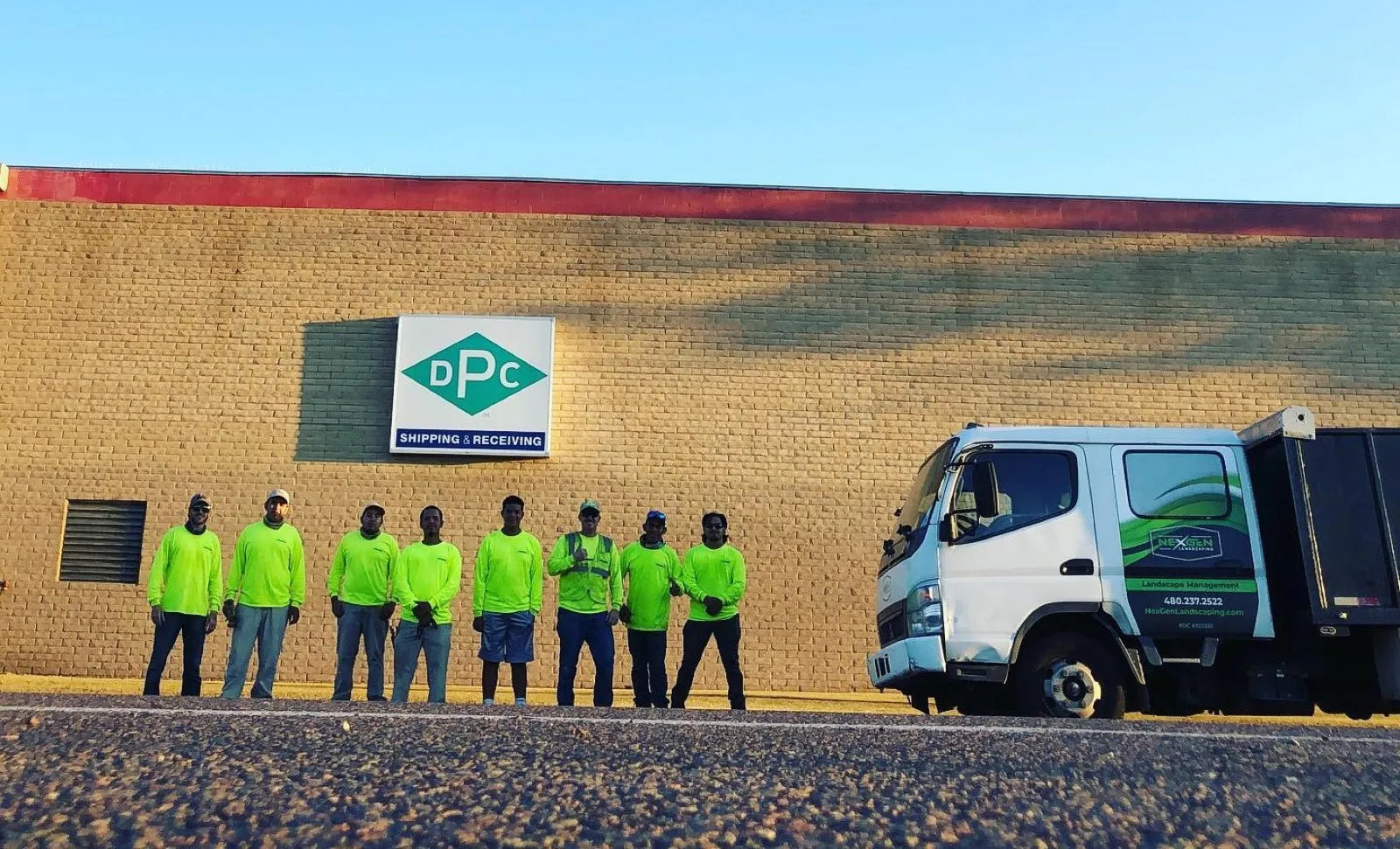 NexGen crew in hi-vis with the branded company truck on a commercial property in the Phoenix Metro